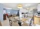 Bright dining area featuring a glass-top table with seating for four and stylish light fixture at 4552 Cr 300, Lake Panasoffkee, FL 33538