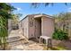 Exterior view of the shed featuring horizontal wood paneling and a light-colored roof at 4552 Cr 300, Lake Panasoffkee, FL 33538