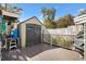 Outdoor storage shed with gray wood-style door, with exterior access and attached deck area at 4552 Cr 300, Lake Panasoffkee, FL 33538