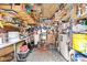 Cluttered storage shed interior showing shelving, tools and equipment, and overhead storage at 4552 Cr 300, Lake Panasoffkee, FL 33538