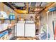 Interior view of utility room with washer, dryer, shelving, and some storage containers at 4552 Cr 300, Lake Panasoffkee, FL 33538