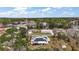 Bird's eye view of home with solar panels and a cozy back patio, nestled in a wooded neighborhood at 50 Pecan Run Crse, Ocala, FL 34472