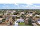 An aerial view of a quaint home with a well-manicured lawn surrounded by lush trees and neighborhood homes at 50 Pecan Run Crse, Ocala, FL 34472