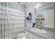 Bathroom featuring a vanity sink and mirror, a white curtain, and soft blue walls at 50 Pecan Run Crse, Ocala, FL 34472