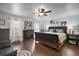 Spacious bedroom featuring a fireplace, ceiling fan, and ample natural light through the windows at 50 Pecan Run Crse, Ocala, FL 34472