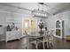 Elegant dining room featuring a modern chandelier, stylish furniture, and plenty of space for gatherings at 50 Pecan Run Crse, Ocala, FL 34472