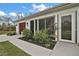 An exterior shot of a house with clean lines and a well-manicured lawn. Includes wood garage door at 50 Pecan Run Crse, Ocala, FL 34472