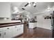 Spacious kitchen featuring dark wood floors, white cabinets and an open design leading to the living room at 50 Pecan Run Crse, Ocala, FL 34472