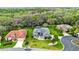 Aerial view of a charming single-story home with lush backyard and mature trees at 5121 Aurora Dr, Leesburg, FL 34748