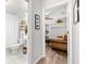 Hallway view into a neutral-colored bathroom with a toilet and sink at 5121 Aurora Dr, Leesburg, FL 34748