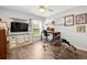 Bright room features wood-look floors, a TV, a desk and shelving at 5121 Aurora Dr, Leesburg, FL 34748