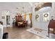 Bright dining room featuring hardwood floors, chandelier lighting, and elegant decor at 5121 Aurora Dr, Leesburg, FL 34748