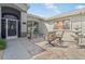 Home's entrance with seating area, water feature and detailed wrought iron door at 5121 Aurora Dr, Leesburg, FL 34748