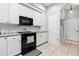 Neat kitchen showcasing modern appliances, sleek black stove top and well-organized cabinetry at 5121 Aurora Dr, Leesburg, FL 34748