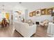 Open-plan living room featuring hardwood flooring, chandelier lighting, and a fireplace at 5121 Aurora Dr, Leesburg, FL 34748