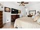 Main bedroom featuring hardwood flooring, a ceiling fan, and a large window at 5121 Aurora Dr, Leesburg, FL 34748