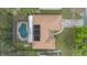 Aerial view of a house with solar panels on the roof and an enclosed pool in the backyard at 516 Spring Oaks Blvd, Altamonte Springs, FL 32714