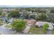 Aerial view of a single-story home with a brown roof, green trees, and a driveway at 516 Spring Oaks Blvd, Altamonte Springs, FL 32714