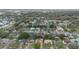 This wide, aerial view captures a leafy residential neighborhood with a water tower in the background at 516 Spring Oaks Blvd, Altamonte Springs, FL 32714