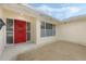 Home featuring a bright red front door with a window and adjacent window to the right at 516 Spring Oaks Blvd, Altamonte Springs, FL 32714