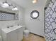 Bathroom featuring a vanity with decorative window and a patterned shower curtain at 6106 Kittiwake Dr, Lakeland, FL 33809