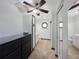 Bathroom featuring dual vanities, tile floors, mirrored closet doors, and a ceiling fan at 6106 Kittiwake Dr, Lakeland, FL 33809