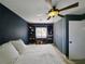 Bedroom with a large bed, custom shelving, and a window seat beneath a multi-blade ceiling fan at 6106 Kittiwake Dr, Lakeland, FL 33809