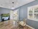 Dining area with a glass table, stylish chairs, shuttered windows and an aquarium at 6106 Kittiwake Dr, Lakeland, FL 33809