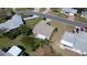 Aerial view showcasing a cozy home with an awning-covered patio, surrounded by lush greenery and neighboring residences at 6106 Kittiwake Dr, Lakeland, FL 33809