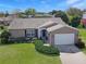 Aerial shot of a well-maintained home with lush landscaping, a spacious driveway, and a charming facade at 6106 Kittiwake Dr, Lakeland, FL 33809