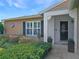 Charming home exterior with neat landscaping, a welcoming entrance, and a brick accent wall at 6106 Kittiwake Dr, Lakeland, FL 33809