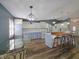 View of the kitchen with an island bar, dining area, and entry, all within a light-filled space at 6106 Kittiwake Dr, Lakeland, FL 33809