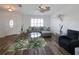 Inviting living room with wood floors, shuttered windows, stylish furniture, and lots of light at 6106 Kittiwake Dr, Lakeland, FL 33809