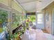 Bright sunroom filled with plants, offering a tranquil view of the lush, green yard at 6106 Kittiwake Dr, Lakeland, FL 33809