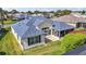 An aerial view of the property with the home's lush landscaping and screen patio at 613 Sherwood St, The Villages, FL 32162