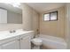 Full bathroom with shower-tub combo, vanity, toilet and window providing natural light at 7266 Swallow Run # 7266, Winter Park, FL 32792