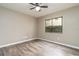 This bedroom features sleek, modern flooring, a ceiling fan, and a window letting in natural light at 7266 Swallow Run # 7266, Winter Park, FL 32792