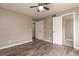 Bedroom featuring a ceiling fan, wood flooring, and convenient access to closet and attached bathroom at 7266 Swallow Run # 7266, Winter Park, FL 32792