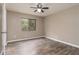 This bedroom features sleek, modern flooring, a ceiling fan, and a window letting in natural light at 7266 Swallow Run # 7266, Winter Park, FL 32792