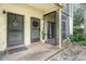 Charming home entrance featuring double doors and a welcoming screened porch at 7266 Swallow Run # 7266, Winter Park, FL 32792