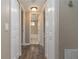 Hallway with wood floors leading to the bathroom at 7266 Swallow Run # 7266, Winter Park, FL 32792