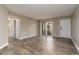 Well-lit living room with a sliding glass door, wood floors and a view of the entry door at 7266 Swallow Run # 7266, Winter Park, FL 32792