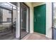 View of the screened porch with a sliding door, green storage door, and view of the complex at 7266 Swallow Run # 7266, Winter Park, FL 32792