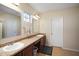 Bathroom with dual sinks, granite countertops, and vanity mirrors, providing style and functionality at 7528 Park Hill Ave, Leesburg, FL 34748