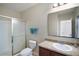 Full bathroom with vanity, mirror and enclosed shower at 7528 Park Hill Ave, Leesburg, FL 34748