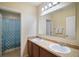 Bathroom with double vanity, large mirror, and shower and tub combination at 7528 Park Hill Ave, Leesburg, FL 34748