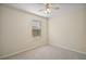 Neutral bedroom with a ceiling fan and window bringing in natural light at 7528 Park Hill Ave, Leesburg, FL 34748