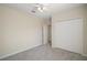 Bright bedroom featuring plush carpet, a ceiling fan, and a closet for ample storage at 7528 Park Hill Ave, Leesburg, FL 34748