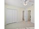 Bedroom featuring tile floors, a ceiling fan, a closet for ample storage, and natural light at 7528 Park Hill Ave, Leesburg, FL 34748