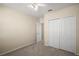 Bedroom featuring plush carpet, ceiling fan, a closet for ample storage and natural light at 7528 Park Hill Ave, Leesburg, FL 34748